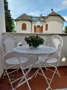 切奇纳Villino Toscana d'Amare con giardino e posto auto privato的天井上摆放着桌椅和盆栽植物