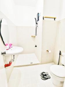 PusokAashvi Cozy Cabin Hostel near Mactan Airport的白色的浴室设有水槽和卫生间。