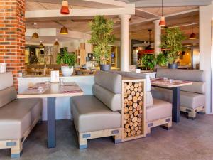 普瓦捷南普瓦捷宜必思酒店的一间带2张桌子和椅子以及柜台的餐厅