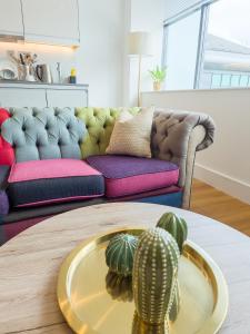 斯劳Captivating 1-Bed Apartment in Slough with Kingbed的客厅配有沙发和带仙人掌的桌子