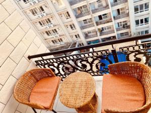 达累斯萨拉姆Platinum apartment的两把藤椅坐在带大楼的阳台