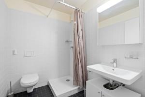 洛桑Boissonnet 96 Residence by Homenhancement的白色的浴室设有水槽和卫生间。