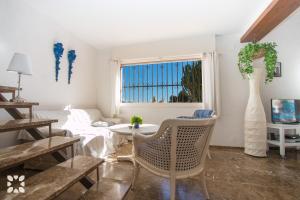 莫莱拉Villa Sol y Sombra by Abahana Villas的客厅配有桌椅和窗户。