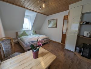 施塔特韦伦Ferienwohnungen Langer的一间卧室配有一张床和一张花瓶桌子