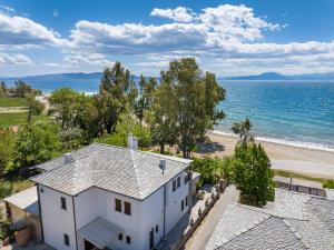 科罗皮Iakovakis Seaside Exclusive Apartments的白色房屋和海滩的空中景致