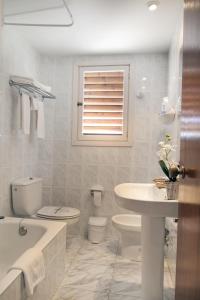 贝尼卡西姆快乐远景酒店的白色的浴室设有卫生间和水槽。