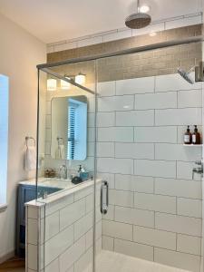 特伦顿Modern Fully Renovated Suite & Loft in Downtown Trenton的一间带玻璃淋浴间和水槽的浴室
