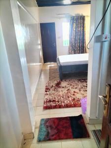 拉穆Olympic Lamu sea front house - 2 bedroom All ensuite的卧室配有一张床,地板上铺有地毯