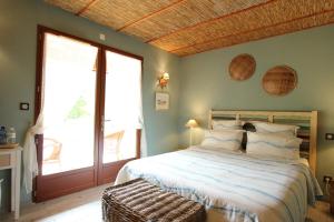 比斯卡罗斯Via Bahia - Maison d'hôtes的一间卧室设有一张床和一个大窗户