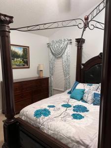 格林斯伯勒Copeland Get-a-Way的一间卧室配有一张带蓝色枕头的天蓬床