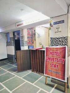 新德里Hotel University Stay @ A1Rooms的一间旅馆大学住宿标志