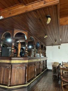 MacachínHotel y Restaurant Don Quijote的一间酒吧,位于一间拥有木制天花板的房间内