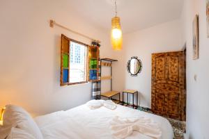 索维拉Giraffe Hostel-Sea view Rooftop的卧室配有白色的床和窗户。