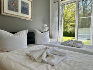 蒂索Haus Sonne的卧室内配有两张带毛巾的白色床。