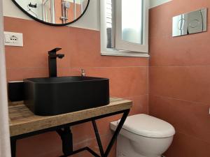 FicarazziM'AMA apartment 1的一间带黑色水槽和卫生间的浴室