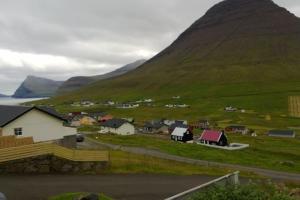 ViðareiðiApartment with a panoramic view的山脚下的小村庄