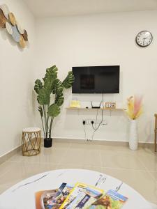 哥打京那巴鲁#8 Summer Seaview Studio Apartment at Kota Kinabalu City Centre的一间客厅,在白色的墙上配有电视