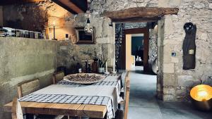罗宾鲁伯龙Chambres B&B dans Authentique Mas de Village avec Piscine的一间设有桌子和石墙的用餐室