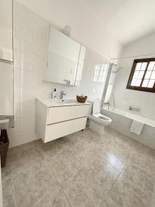 佩亚Villa Chara Spectacular panoramic views!的一间带水槽、卫生间和镜子的浴室