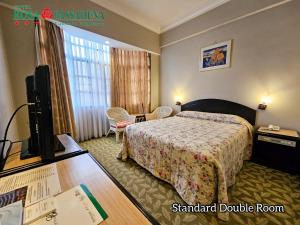金马仑高原罗萨帕萨德纳极度的配有一张床和一台平面电视的酒店客房