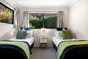 皇后镇Distinctive Stylish and Spacious Family Home的小型客房 - 带2张床和窗户