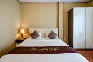 胡志明市La Palma - Garden Saigon Hotel Phu My Hung的一间卧室配有一张带白色床罩的大床