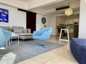 利马索尔Helena Beach by TrulyCyprus的客厅配有蓝色椅子和沙发