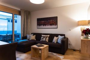 滨湖采尔Spa Apartments - Zell am See的客厅配有沙发和桌子