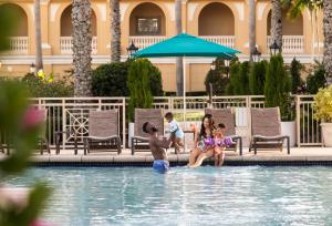 萨拉索塔The Ritz-Carlton, Sarasota的住在度假村游泳池里的家庭