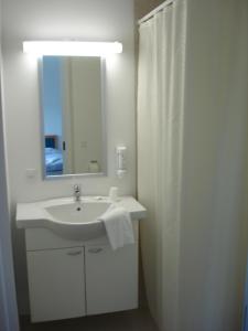 格雷诺Hotel Havlund Bed and Breakfast的白色的浴室设有水槽和镜子