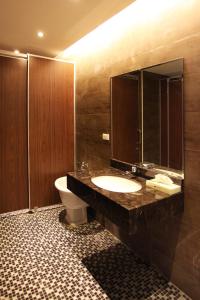 朴子山海大饭店的一间带水槽、卫生间和镜子的浴室