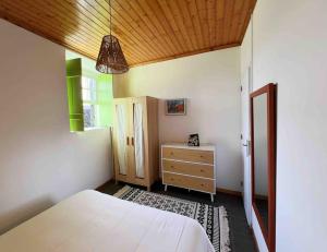 马达莱纳Casa do Cacto - 1 Bedroom Cosy Flat的卧室设有白色的床和木制天花板。