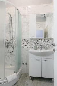 特罗吉尔Rooms Anna的白色的浴室设有水槽和淋浴。
