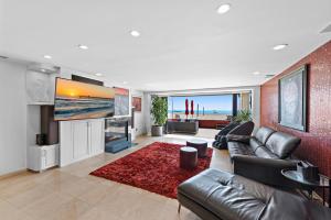 纽波特海滩3 Story Oceanfront Home with Jacuzzi in Newport Beach on the Sand!的客厅配有真皮沙发和电视