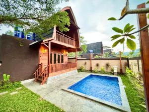 安耶尔Nemuru Villa Ubud Anyer的庭院中带游泳池的房子