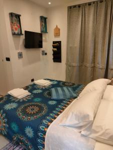 卡莱扎诺La petite suite的一间卧室配有一张带蓝色毯子的床