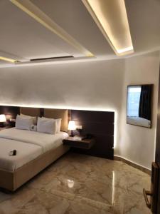IloraLe Masik Hotel的一间卧室设有一张大床和一个窗户。