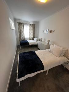 卡迪夫Spacious Family home in great location in Cardiff的一间卧室配有一张大床和一张沙发