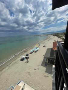 帕拉利亚卡泰里尼斯Nepheli的沙滩上,有遮阳伞和人