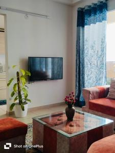 班加罗尔SOLACE Premium 3BHK Apartment Manyata Tech Park and Mall of Asia的客厅设有壁挂式平面电视。
