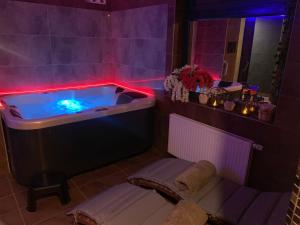 PorubaRefresh Club wellness的浴室配有带灯的浴缸。