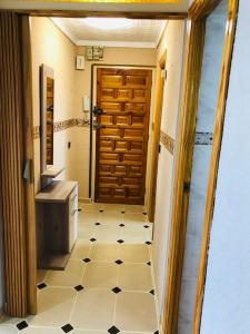 普埃托利亚诺Acogedor apartamento muy cerca del centro的浴室设有门,铺有瓷砖地板。