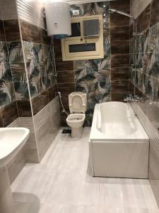 马达巴Jordan road Guest House的浴室配有卫生间、盥洗盆和浴缸。