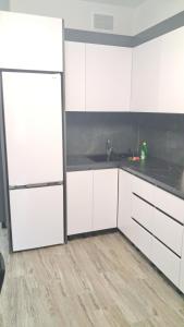 CodruAIRHOTEL的厨房配有白色橱柜和台面