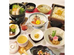 鸳泊Rishiri Fuji Kanko Hotel - Vacation STAY 63409v的餐桌,盘子上放着食物和碗