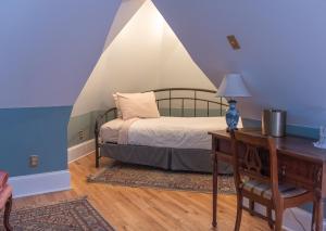 伊萨卡William Henry Miller Inn的一间卧室配有一张床和一张带台灯的书桌
