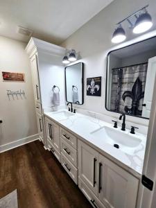 查尔斯湖Louisiana 5BR Luxury Pool Retreat的一间带两个盥洗盆和大镜子的浴室
