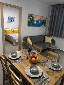 Néa Alikarnassósmodern apt near Heraklion city & airport的一张带一碗水果的餐桌和一间客厅