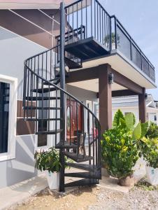 珍南海滩Villa Adeeva Homestay Langkawi的植物屋旁的螺旋楼梯