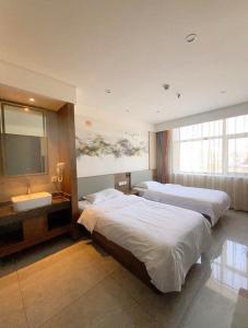 房山区比邻酒店(北京房山区良乡医院店)的酒店客房设有两张床和电视。